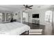 Large main bedroom features dark wood floors, TV and an arched entry to ensuite bath at 4497 E Carriage Way, Gilbert, AZ 85297