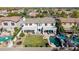 An attractive house features a swimming pool, verdant lawn, desert landscaping, and large back patio with ample seating at 4497 E Carriage Way, Gilbert, AZ 85297