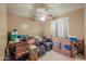 Bedroom filled with boxes featuring a ceiling fan and window with plantation shutters at 4560 E Paso Trl, Phoenix, AZ 85050