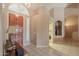 Entryway with tile floor, decorative table, and door leading to the laundry room at 4560 E Paso Trl, Phoenix, AZ 85050