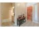 A home's entryway features tile floors, a decorative table, and a solid wood door at 4560 E Paso Trl, Phoenix, AZ 85050