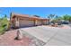 Exterior view of a three-car garage with concrete driveway and desert landscaping at 4560 E Paso Trl, Phoenix, AZ 85050