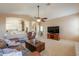 Spacious living room with a large TV and leather furniture at 4560 E Paso Trl, Phoenix, AZ 85050