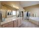 Bathroom boasts double sinks, vanity and mirror, shower, soaking tub and tile floor at 4560 E Paso Trl, Phoenix, AZ 85050