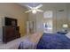 Spacious primary bedroom featuring a ceiling fan, neutral carpet and ensuite bath with a tub at 4560 E Paso Trl, Phoenix, AZ 85050