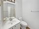 Well-lit bathroom with a toilet, a sink, mirror, and shower at 5501 W Whispering Wind Dr, Glendale, AZ 85310
