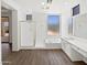 Bright bathroom featuring a glass enclosed shower, soaking tub, dual sinks, and natural light at 5501 W Whispering Wind Dr, Glendale, AZ 85310