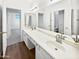 Bright bathroom features a dual sink vanity, large mirror, and plenty of storage space at 5501 W Whispering Wind Dr, Glendale, AZ 85310