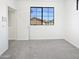 Bedroom featuring plush carpeting and a window with neighborhood views at 5501 W Whispering Wind Dr, Glendale, AZ 85310