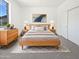 Bright bedroom featuring a large bed, stylish dresser, and soft natural lighting at 5501 W Whispering Wind Dr, Glendale, AZ 85310