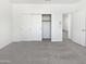 Spacious bedroom with plush carpeting, closet and an entry doorway at 5501 W Whispering Wind Dr, Glendale, AZ 85310