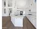 Open kitchen boasts a large island, white cabinetry, stainless steel appliances, and great lighting at 5501 W Whispering Wind Dr, Glendale, AZ 85310