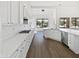 Spacious kitchen with white cabinets, stainless appliances and large windows for ample natural light at 5501 W Whispering Wind Dr, Glendale, AZ 85310