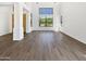 Bright living room with beautiful luxury vinyl flooring and tall ceilings with natural light at 5501 W Whispering Wind Dr, Glendale, AZ 85310