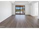Bright living room with beautiful luxury vinyl flooring and sliding glass doors with outdoor view at 5501 W Whispering Wind Dr, Glendale, AZ 85310