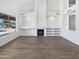 Bright living room offers natural light, vaulted ceilings, cozy fireplace and laminate flooring at 5501 W Whispering Wind Dr, Glendale, AZ 85310