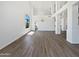 Bright living room with beautiful luxury vinyl flooring and tall ceilings with decorative chandelier at 5501 W Whispering Wind Dr, Glendale, AZ 85310