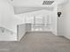 Bright loft area featuring carpet and railing at 5501 W Whispering Wind Dr, Glendale, AZ 85310