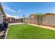 Well-maintained backyard with artificial turf, basketball hoop, and string lights at 5526 W Ellis Dr, Laveen, AZ 85339