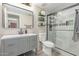 Bathroom with gray vanity, shower with glass doors, and decorative shelves at 5526 W Ellis Dr, Laveen, AZ 85339