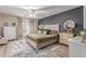 Stylish bedroom with a grey accent wall, elegant furnishings, a ceiling fan, and natural light at 5526 W Ellis Dr, Laveen, AZ 85339