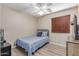 Cozy bedroom with blue bedding, ceiling fan, and wood-look flooring at 5526 W Ellis Dr, Laveen, AZ 85339