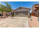 View of home's front exterior with driveway and attached two-car garage at 5526 W Ellis Dr, Laveen, AZ 85339