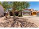 Charming single-story home with a well-kept front yard and a two-car garage at 5526 W Ellis Dr, Laveen, AZ 85339