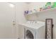 Laundry room with white washer and dryer and storage shelves at 5526 W Ellis Dr, Laveen, AZ 85339