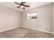 Comfortable bedroom with carpet, ceiling fan, and a window offering natural light at 5627 E Covina Rd, Mesa, AZ 85205