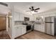 Charming kitchen boasts white cabinets, stainless steel appliances and a cozy breakfast nook at 5627 E Covina Rd, Mesa, AZ 85205