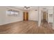 Spacious living room with wood-look floors, ceiling fan, and a window overlooking the front yard at 5627 E Covina Rd, Mesa, AZ 85205