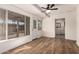Bright sunroom with updated flooring and seamless access to a bathroom at 5627 E Covina Rd, Mesa, AZ 85205