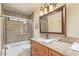 Elegant bathroom with decorative mirror, granite counters, and tiled walk-in shower at 6073 E Beck Ln, Scottsdale, AZ 85254