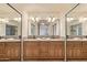 Bathroom showcasing a double sink vanity and well-lit mirrors at 6073 E Beck Ln, Scottsdale, AZ 85254