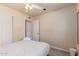 This bedroom features a ceiling fan and ensuite doors for privacy at 6073 E Beck Ln, Scottsdale, AZ 85254