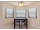 Bright breakfast nook with tile floors, large windows and modern lighting fixture at 6073 E Beck Ln, Scottsdale, AZ 85254