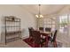 Cozy dining room featuring a modern chandelier, a marble-topped table, and an iron wine rack at 6073 E Beck Ln, Scottsdale, AZ 85254