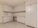 Functional garage with cabinets and workbench, providing ample storage and workspace for hobbies or projects at 6073 E Beck Ln, Scottsdale, AZ 85254