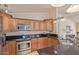 Kitchen boasts stainless steel appliances, granite countertops, and wood cabinets at 6073 E Beck Ln, Scottsdale, AZ 85254