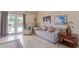 Comfortable living area with a sofa, recliner, and view of the pool, perfect for relaxing and enjoying the indoor-outdoor lifestyle at 6073 E Beck Ln, Scottsdale, AZ 85254