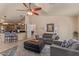 Relaxing living room showcasing an open floor plan, an ottoman, comfortable seating, and a breakfast bar to the kitchen at 6073 E Beck Ln, Scottsdale, AZ 85254