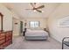 Spacious main bedroom featuring a ceiling fan, closet, and ensuite bathroom at 6073 E Beck Ln, Scottsdale, AZ 85254