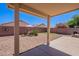 The backyard features desert landscaping, a covered patio, and block fencing at 645 W Kingman Loop, Casa Grande, AZ 85122