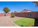 The backyard features desert landscaping, artificial turf, and block fencing at 645 W Kingman Loop, Casa Grande, AZ 85122