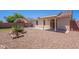 The backyard features desert landscaping and a covered patio at 645 W Kingman Loop, Casa Grande, AZ 85122