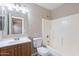 Bathroom featuring vanity, mirror, toilet, and shower-tub combo at 645 W Kingman Loop, Casa Grande, AZ 85122