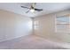 Spacious carpeted bedroom with ceiling fan and two windows with bamboo blinds at 645 W Kingman Loop, Casa Grande, AZ 85122