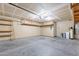 The garage features concrete flooring, shelving, and access door to the backyard at 645 W Kingman Loop, Casa Grande, AZ 85122