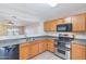 Well-lit kitchen with wooden cabinets and stainless steel appliances at 645 W Kingman Loop, Casa Grande, AZ 85122